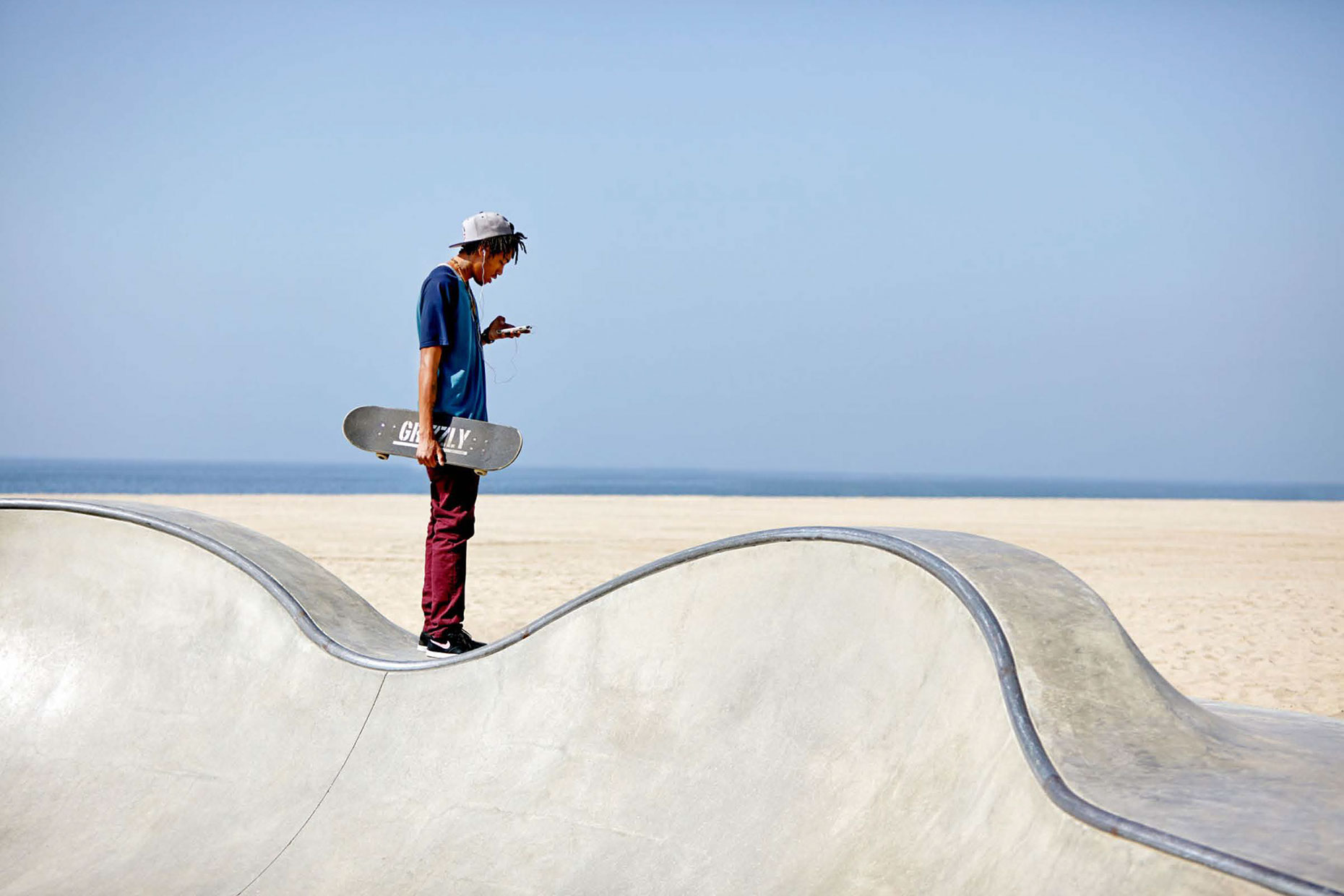 Photography_Lifestyle_Beach Skate Park Kid on Cell Phone-Tony Garcia