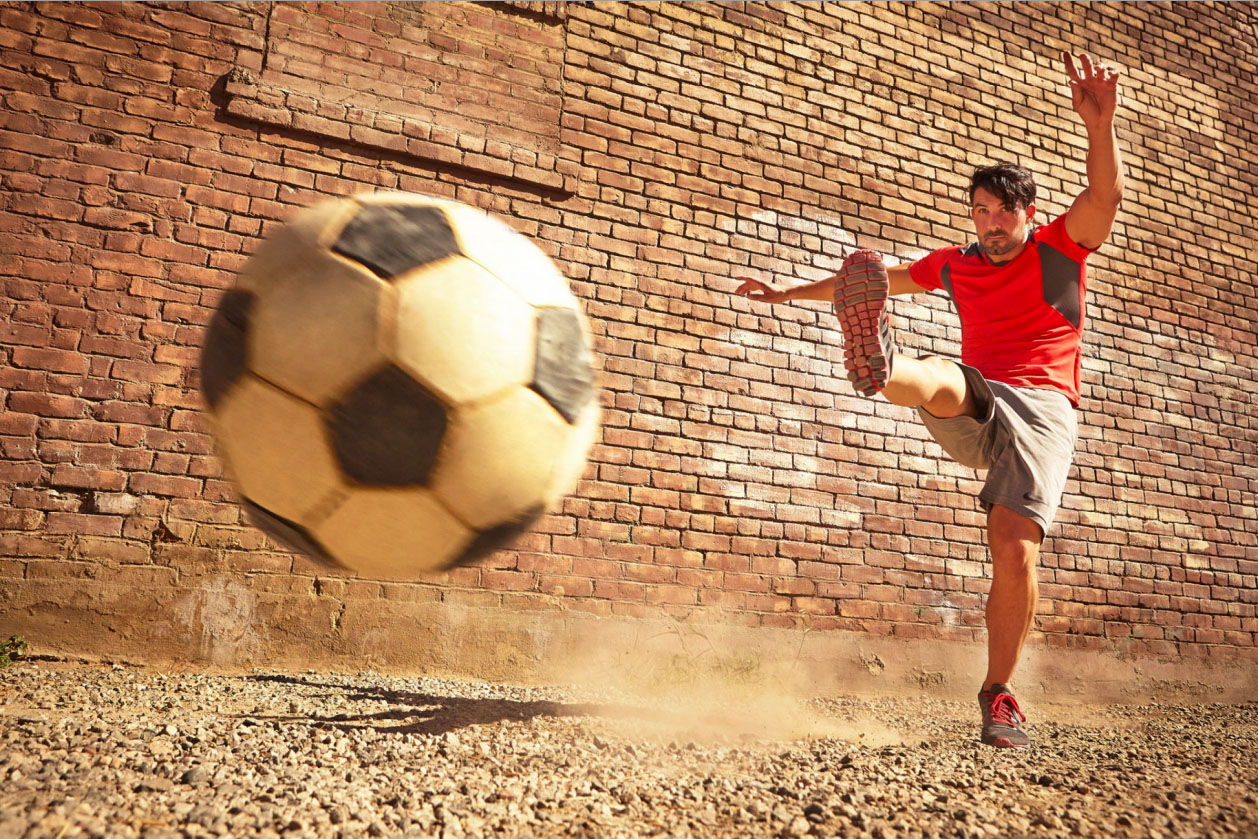 Photography_Sports and Fitness_Guy Kicking Soccer Ball Red Shirt-Tony Garcia