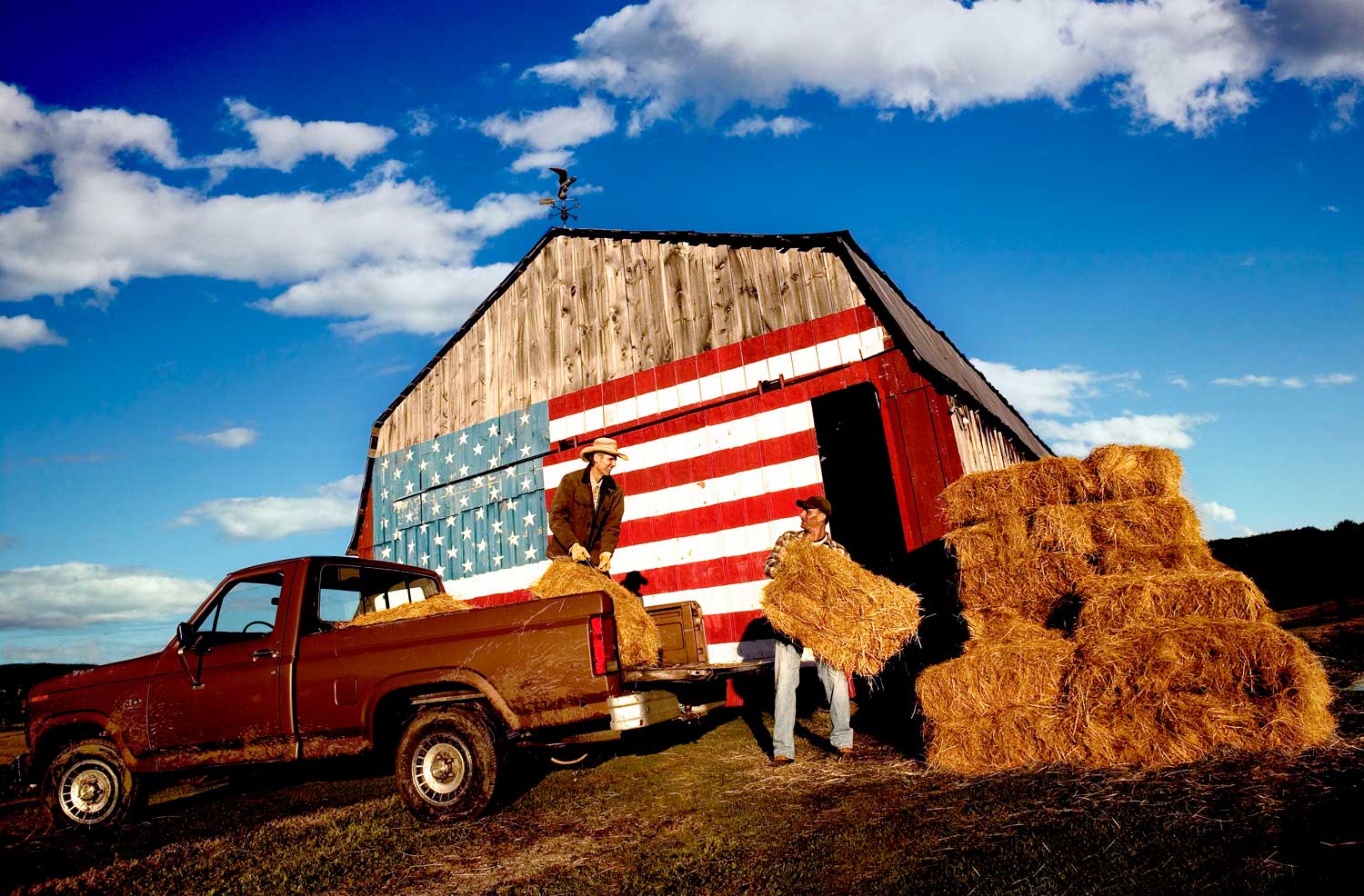 Skoal_Flag-farmers pitching haybales onto pickup truck