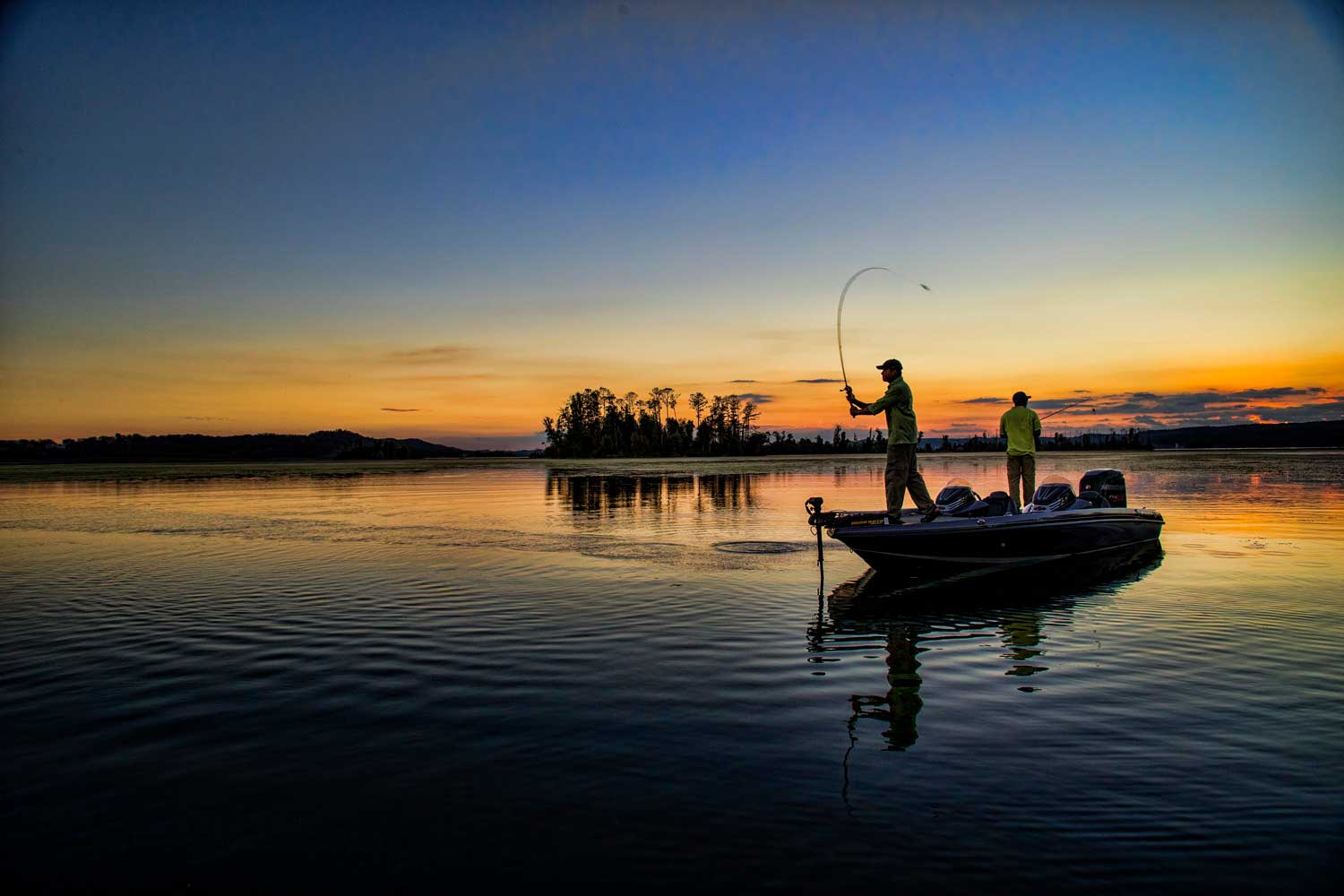 casting-fisherman-on-lake-at-sunrise