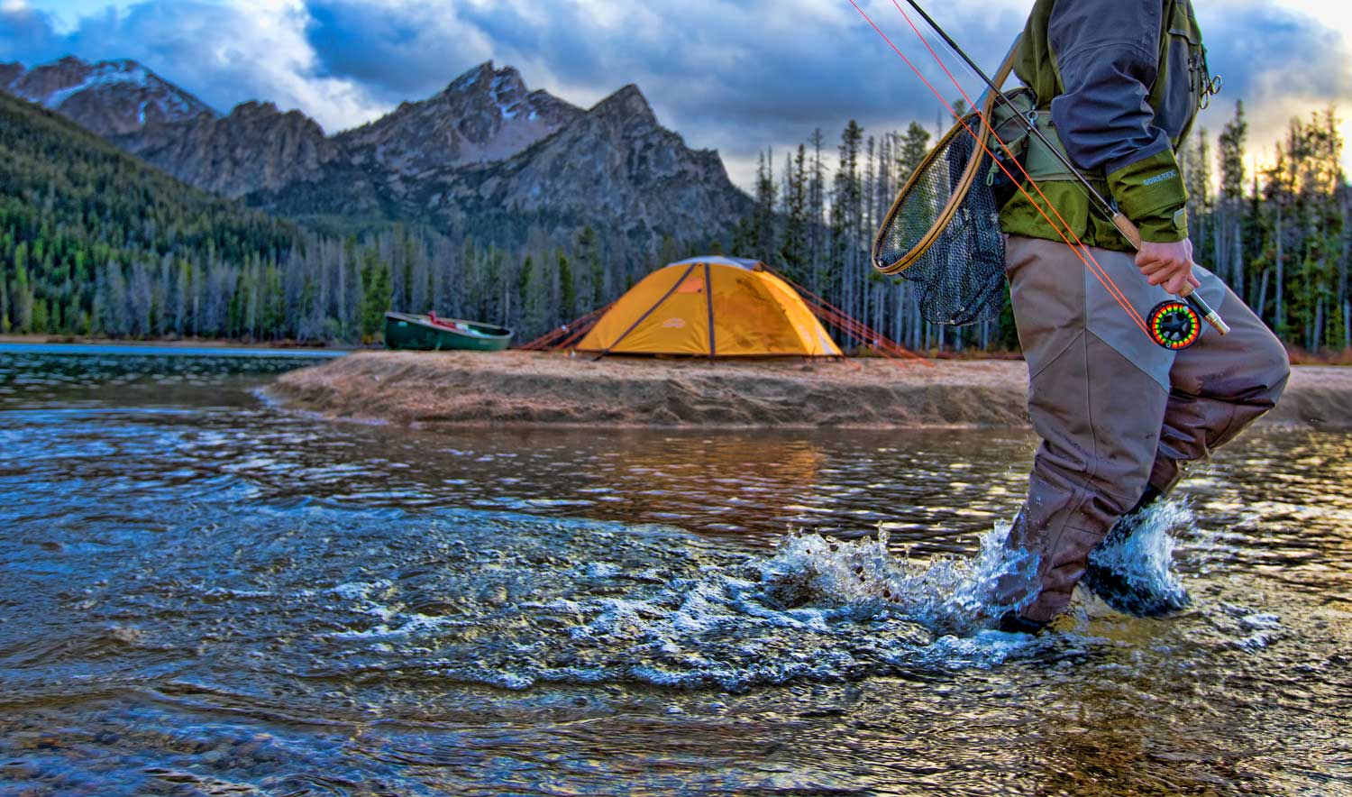 running-fly-fisherman-with-mountain-and-tent-back-drop