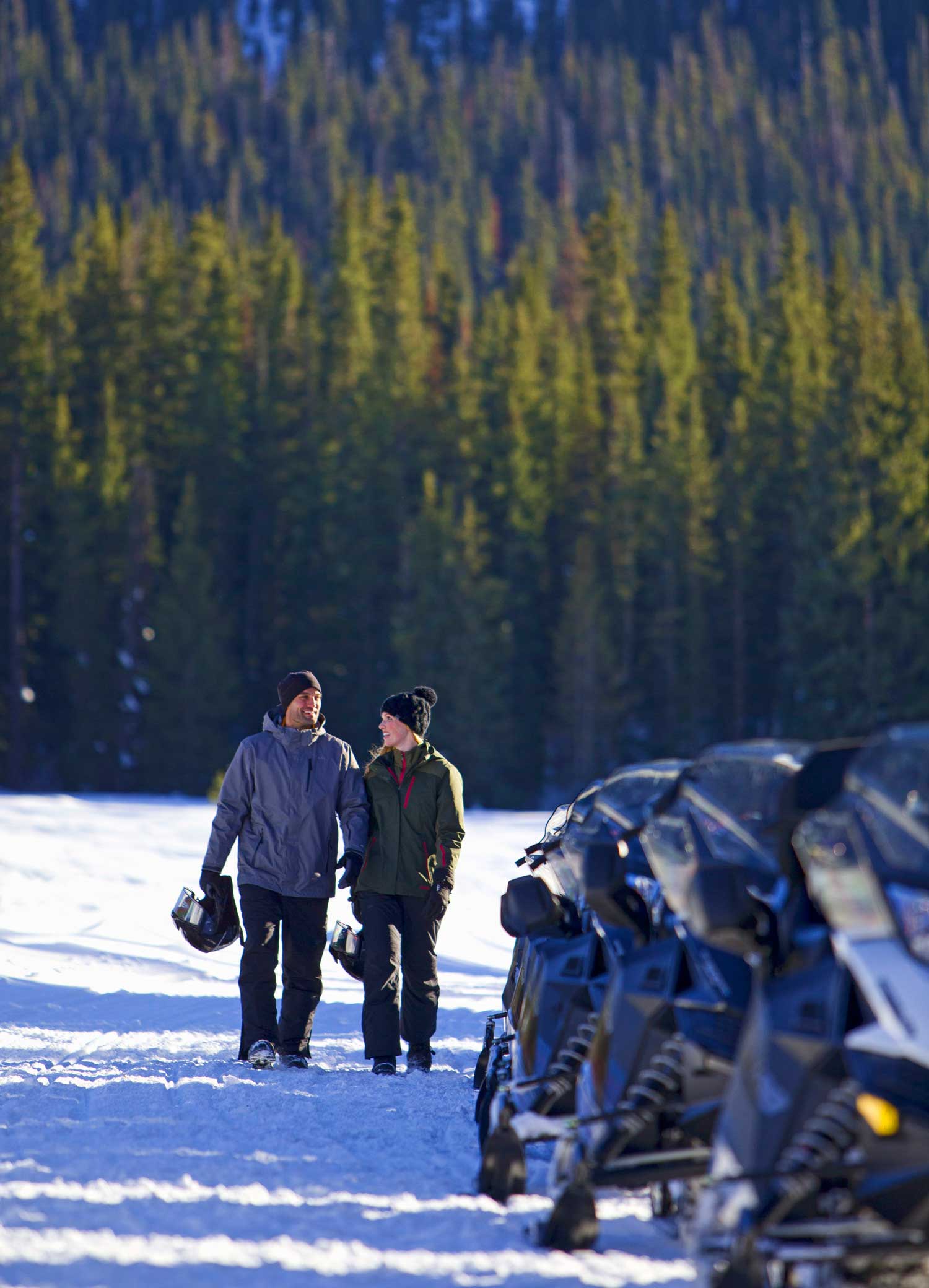 snowmobile-man-woman-couple--walking-to-snowmobile